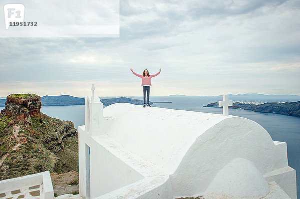 Mädchen oben auf der Kirche stehend  Oía  Santorini  Kikladhes  Griechenland