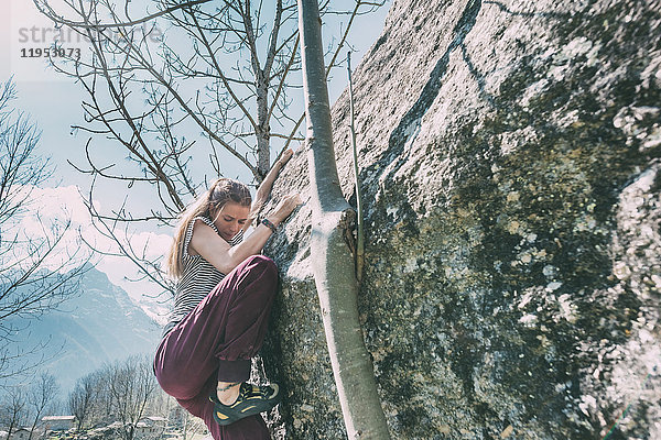 Junge weibliche Bouldererin beim Bouldern  Lombardei  Italien