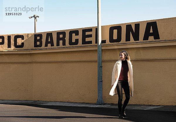 Weibliche Touristin bei einem Mauerspaziergang mit Barcelona in Großbuchstaben  Barcelona  Spanien