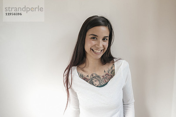 Porträt einer lächelnden Frau mit Tattoos