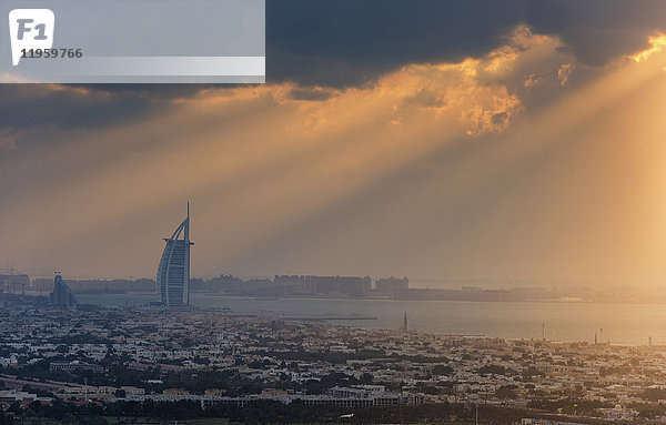 Stadtbild von Dubai  Vereinigte Arabische Emirate in der Abenddämmerung mit dem Wolkenkratzer Burj Al Arab in der Ferne.