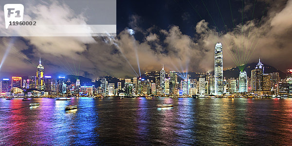 Luftaufnahme des Stadtbildes von Hongkong mit beleuchteten Wolkenkratzern in der Abenddämmerung.