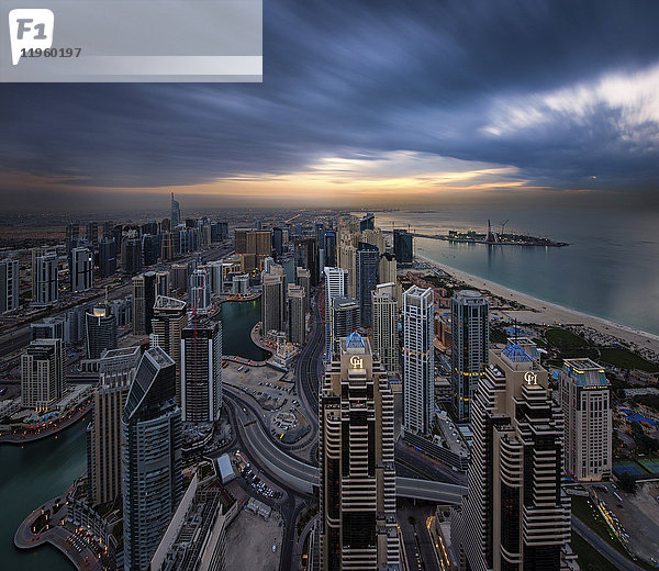 Stadtbild von Dubai  Vereinigte Arabische Emirate in der Abenddämmerung  mit Wolkenkratzern an der Küste des Persischen Golfs.