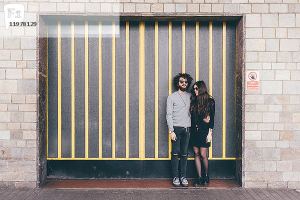 Porträt eines jungen Mannes und einer jungen Frau  die zusammen in einem Schutzraum auf der Straße stehen