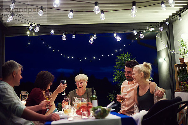 Gruppe von Personen  die am Tisch sitzen und eine Mahlzeit genießen