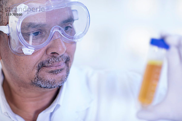 Laborantin untersucht flüssigkeitsgefülltes Reagenzglas  Nahaufnahme