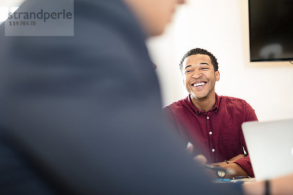 Blick über die Schulter eines jungen Geschäftsmannes am Büroschreibtisch