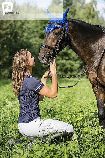 Junge Frau und Pferd auf dem Feld