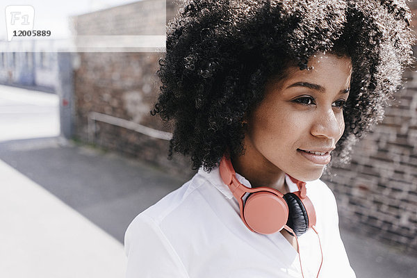 Junge Frau mit Kopfhörer im Freien