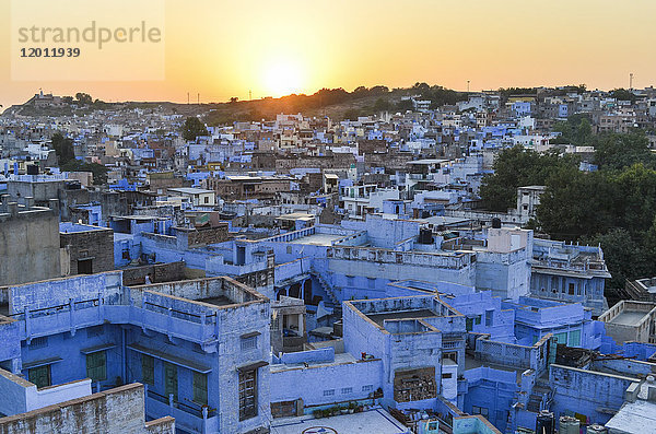 Sonnenuntergang und das verblassende glühende Licht auf den Dächern der blau-weißen Gebäude der Stadt Jodhpur.