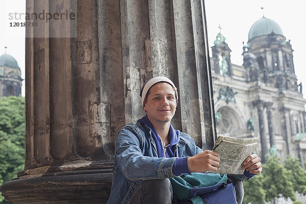 Niederwinkelporträt eines jungen Touristen mit Karte im Alten Museum  Berlin  Deutschland