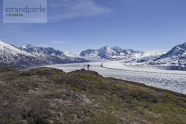 Volle Länge des Wanderers mit Blick auf Gletscher gegen blauen Himmel  Knik-Gletscher  Palmer  Alaska