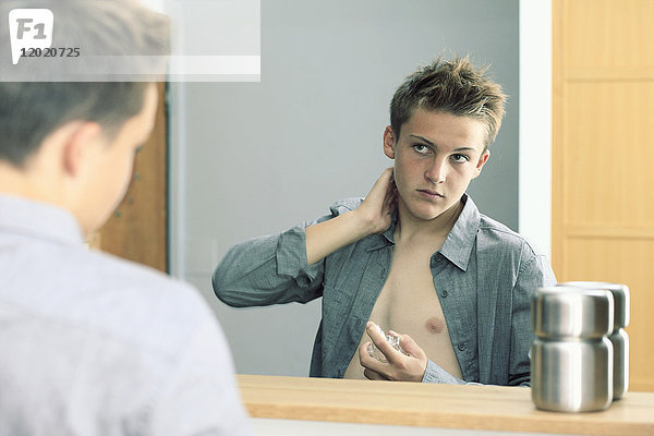 Frankreich  Teenager in seinem Badezimmer  der Parfüm benutzt.