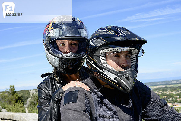 Glückliches junges Bikerpaar beim Motorradfahren im Sommer.