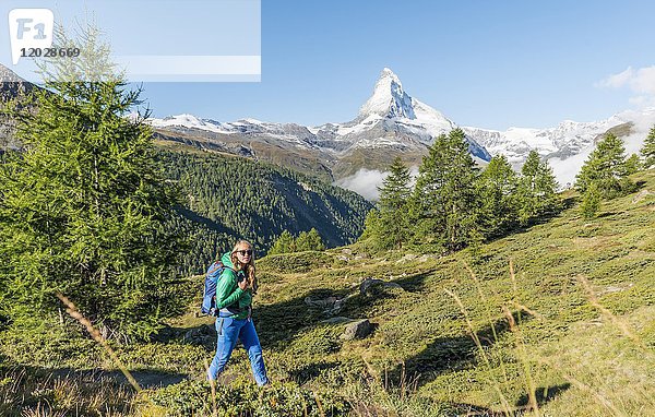 Wanderer auf dem 5-Seen-Wanderweg  im Rücken das schneebedeckte Matterhorn  Wallis  Schweiz  Europa