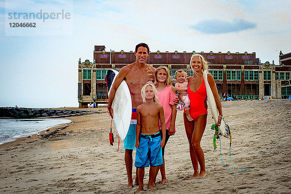 Porträt eines surfenden Ehepaares mit Sohn und Tochter am Strand  Asbury Park  New Jersey  USA