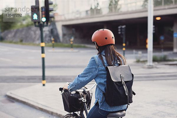 Rückansicht der Frau beim Radfahren auf der Straße