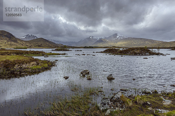 Moorlandschaft mit einem Fluss und Gewitterwolken im Rannoch Moor in Schottland  Vereinigtes Königreich