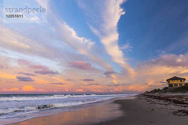 Sonnenuntergang über einem Strand und einem gelben Haus an der Atlantikküste; Satellite Beach  Florida  Vereinigte Staaten von Amerika