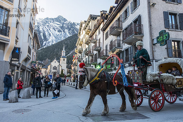 Touristen fahren in einem von einem Pferd gezogenen Buggy durch die Straßen; Chamonix  Frankreich