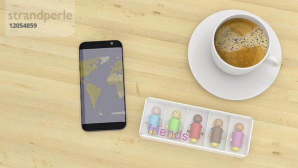 Multi Rassenpuppen auf einem Schreibtisch mit Tasse Kaffee und Smartphone