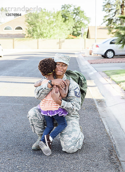Schwarze Soldatin begrüßt Tochter auf der Straße