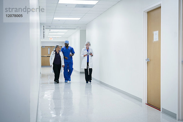 Ärzte und Krankenschwester gehen im Krankenhaus spazieren