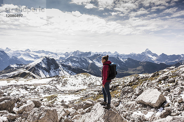 Deutschland  Bayern  Oberstdorf  Frau auf Felsen stehend in alpiner Landschaft