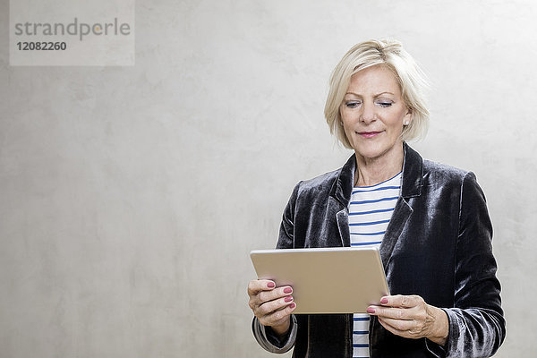 Porträt einer älteren Frau mit Tablette