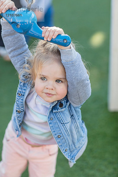 Mädchen in der Vorschule  hält Spielplatz Seilschaukel im Garten