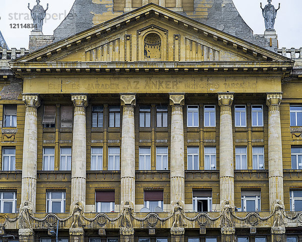 Gebäude mit verwitterter Fassade aus Säulen und Fenstern und dekorativen Elementen; Budapest  Budapest  Ungarn