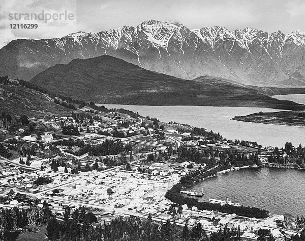 Laterna Magica um 1900  viktorianische/edwardianische Sozialgeschichte. Ein Blick von den Hügeln auf Queenstown und die Remarkables. Neuseeländischer Hafen mit Schiffen und Raddampfern