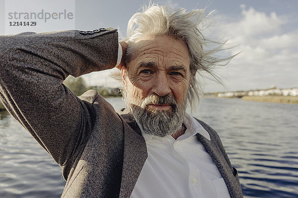 Porträt eines ernsthaften älteren Mannes am See