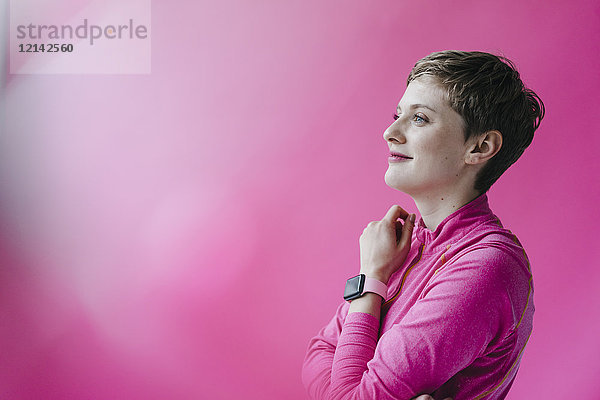 Frau in rosa Sportbekleidung trägt smartwatch