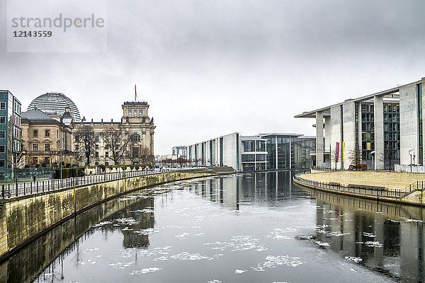Deutschland  Berlin  Berlin-Mitte  Regierungsviertel  Reichstag und Paul-Loebe-Gebäude mit Spree im Vordergrund im Winter
