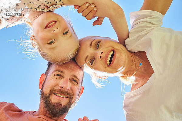 Porträt einer glücklichen Familie unter blauem Himmel
