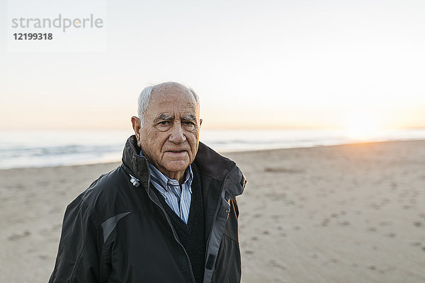 Ein älterer Mann  der am Strand spazieren geht.