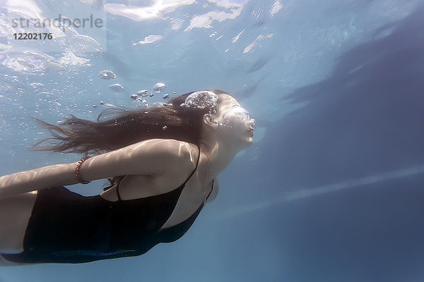 Junge Frau unter Wasser im Schwimmbad