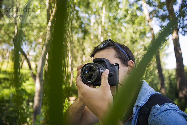 Mann fotografiert im Wald