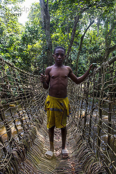 Pygmäenmann auf einer handgefertigten Lianenbrücke im Dzanga-Sangha-Park  UNESCO-Welterbe  Zentralafrikanische Republik  Afrika