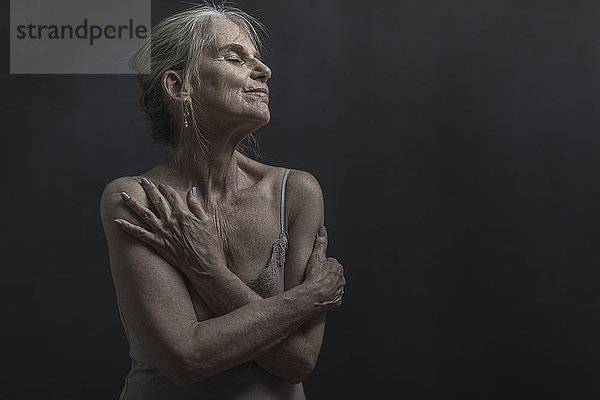 Portrait of daydreaming older Caucasian woman