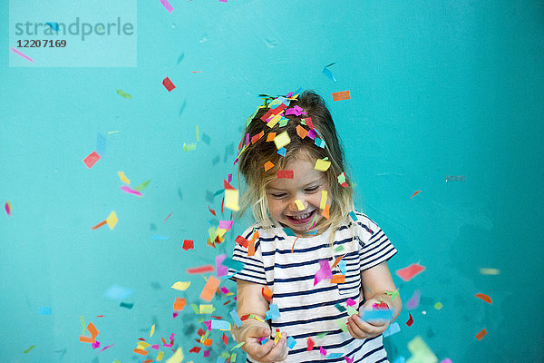 Colorful confetti falling on Caucasian girl