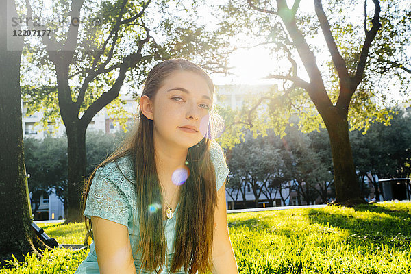 Portrait of serious Caucasian girl in park