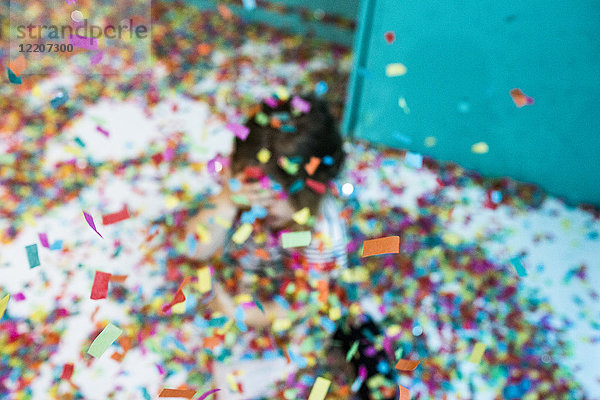 Colorful confetti falling on Caucasian girl