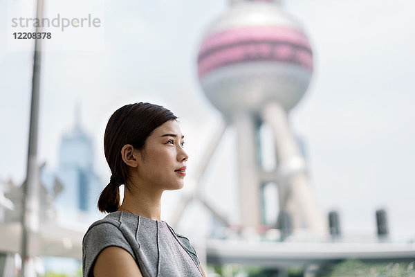 Junge Geschäftsfrau mit Blick auf das Finanzzentrum Shanghai  Shanghai  China