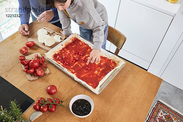 Großmutter und Enkel machen Pizza in der Küche  erhöhte Ansicht
