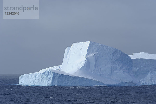 Teil eines Eisbergs  der das Licht an einem bedeckten Tag im Antarktischen Sund auf der Antarktischen Halbinsel reflektiert  Antarktis