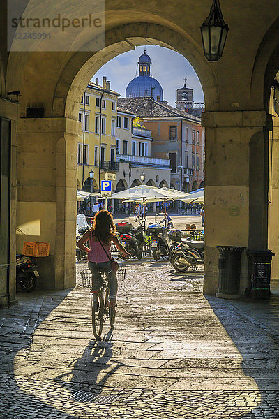 Blick auf Radfahrer und Piazza delle Erbe durch Torbögen und Kuppel von Padua Catherdal sichtbar  Padua  Veneto  Italien  Europa
