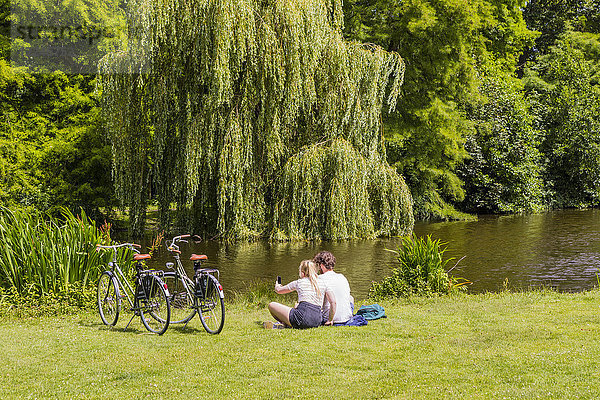 Paar sitzt im Vondelpark  Amsterdam  Niederlande  Europa