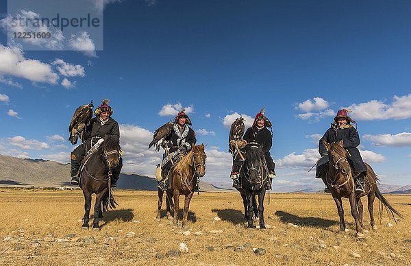 Mongolische Adlerjäger auf Pferden in der Wüste  Mongolei  Asien